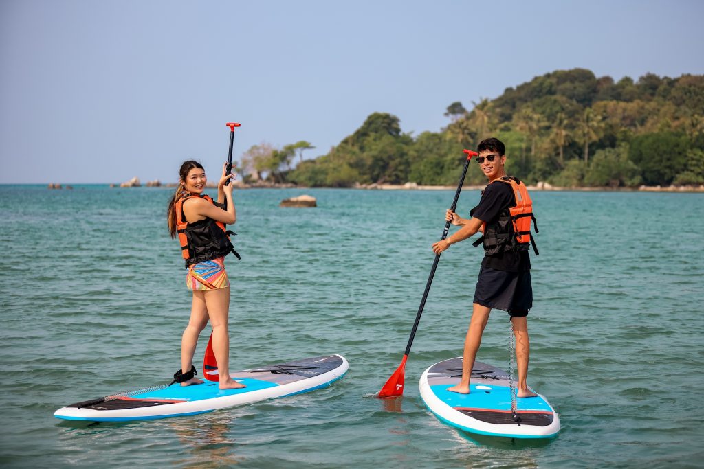 Paddleboarders on calm waters at Lagoi Bay Beach